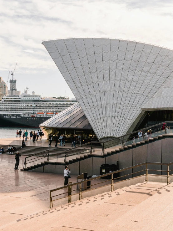 a group of people that are standing in front of a building, inspired by Sydney Carline, pexels contest winner, modernism, khedival opera house, ships with sails underneath, slide show, exterior shot