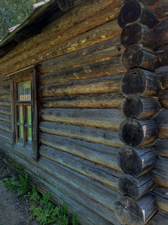 a log cabin with logs on the side of it, by Jacob Kainen, pexels contest winner, renaissance, 4k detail post processing, 1852, front side, shot on sony a 7