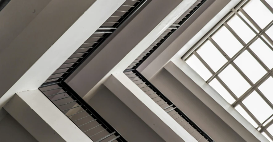 a very tall building with a lot of windows, inspired by Alexander Rodchenko, pexels contest winner, light and space, 1 staircase, angular metal, white ceiling, architectural painting