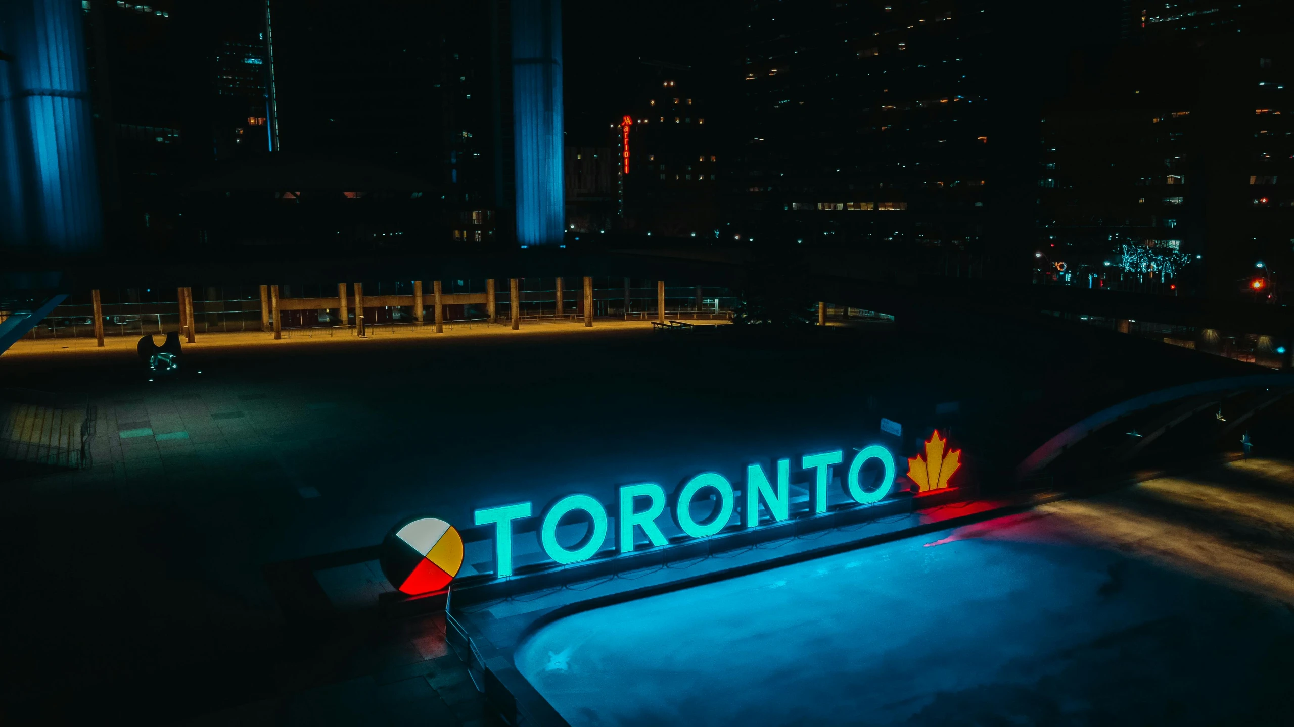 a neon sign sitting in the middle of a parking lot, by Seb McKinnon, pexels contest winner, the city of toronto, illuminated pool, view from bottom to top, promo material