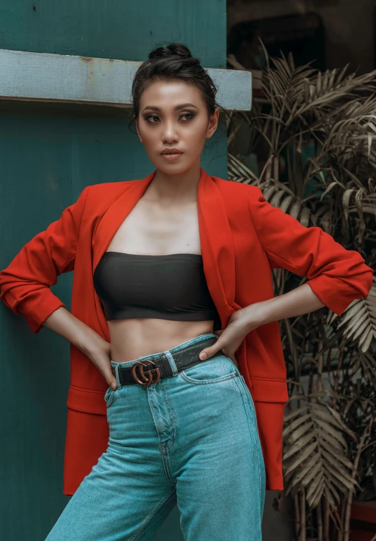 a woman posing with her hands on her hips, inspired by Natasha Tan, trending on pexels, sumatraism, red jacket, croptop, vouge style photo, handsome girl