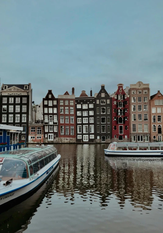 a group of boats floating on top of a river, by Jacob Koninck, pexels contest winner, renaissance, round buildings in background, slide show, amsterdam, 8k uhd”