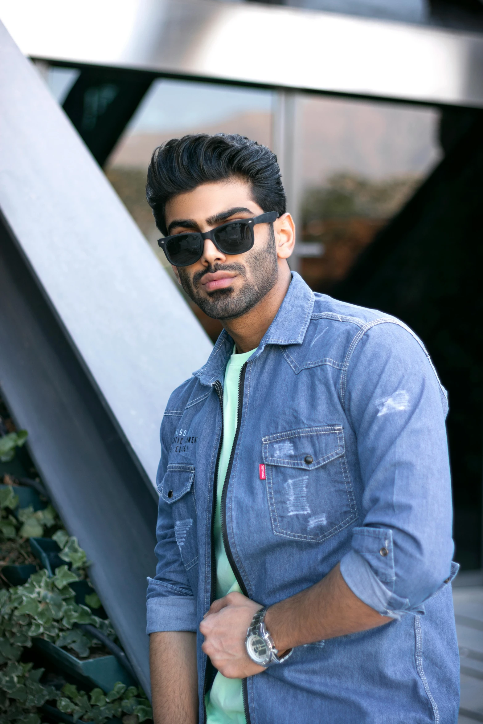 a man wearing sunglasses standing in front of a building, trending on pexels, hurufiyya, a portrait of rahul kohli, wearing a jeans jackets, headshot profile picture, zayn malik