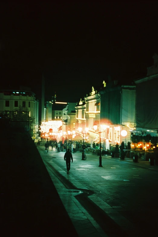 a group of people walking down a street at night, unsplash, renaissance, ground level view of soviet town, 1999 photograph, square, festival. scenic view at night