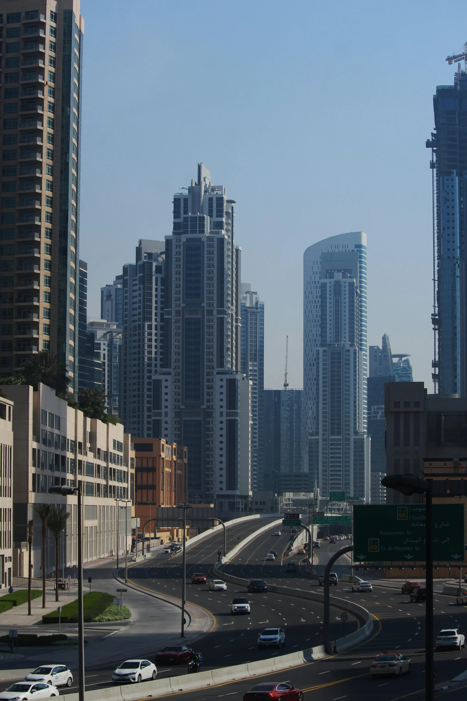 a city filled with lots of tall buildings, sheikh, city bay bridge aqueduct, from street level, majestic spires