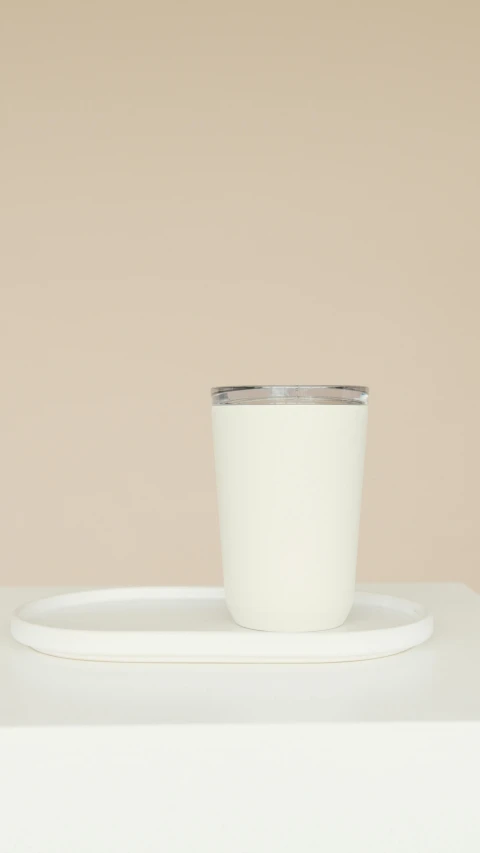 a white cup sitting on top of a white plate, metal lid, cascadian, matte surface, milkshake