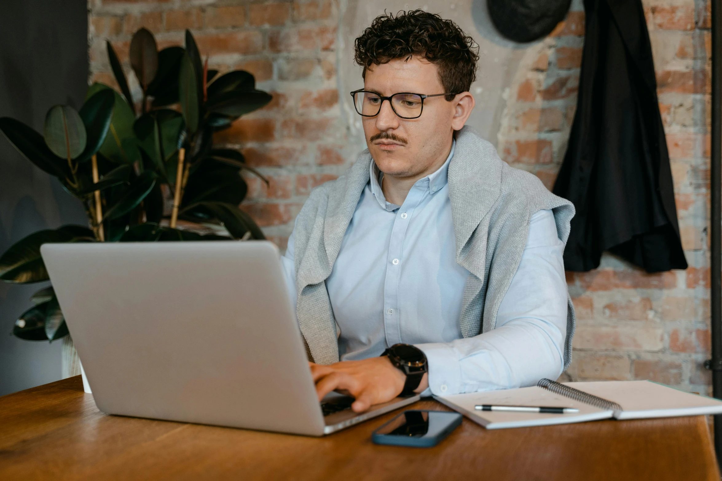 a man sitting in front of a laptop computer, trending on pexels, lachlan bailey, avatar image, wearing business casual dress, concentration