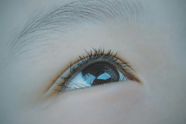 a close up of a child's blue eye, a photorealistic painting, by Ye Xin, trending on pexels, eyebrow scar, low - angle shot, asian hyperdetailed, photo realistic image