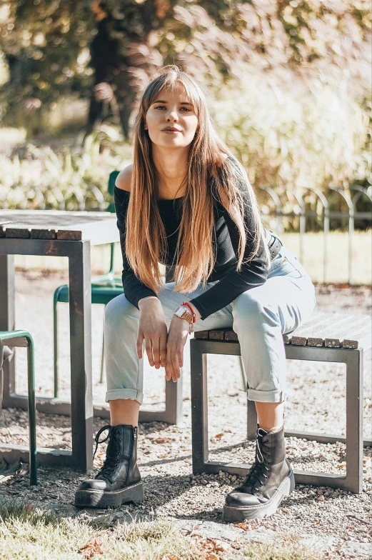 a woman sitting on a bench in a park, a portrait, pexels contest winner, happening, wearing jeans, pokimane, sitting at table, profile image