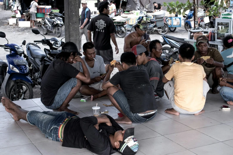 a group of people that are sitting on the ground, by Basuki Abdullah, trading illegal goods, hot food, thumbnail, square