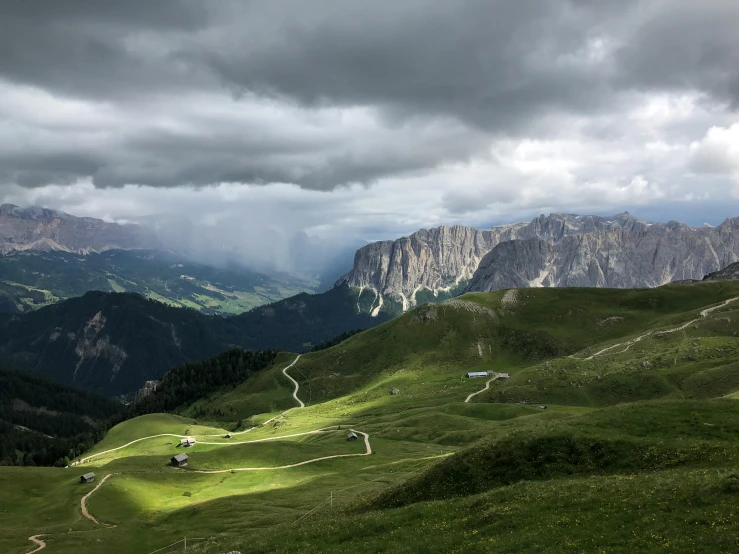 a view of the mountains from the top of a hill, by Alessandro Allori, pexels contest winner, renaissance, stormy lighting, green valley below, grey, conde nast traveler photo