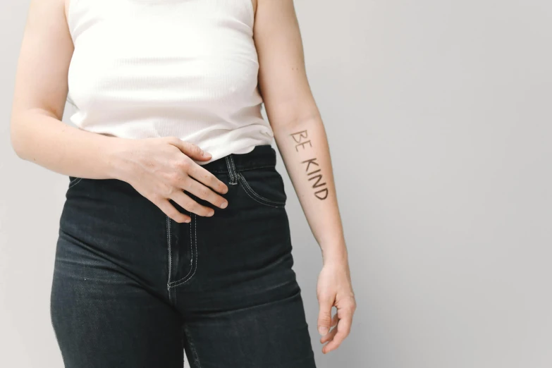 a woman with a tattoo on her arm, trending on pexels, kindness, set against a white background, stamped, background image