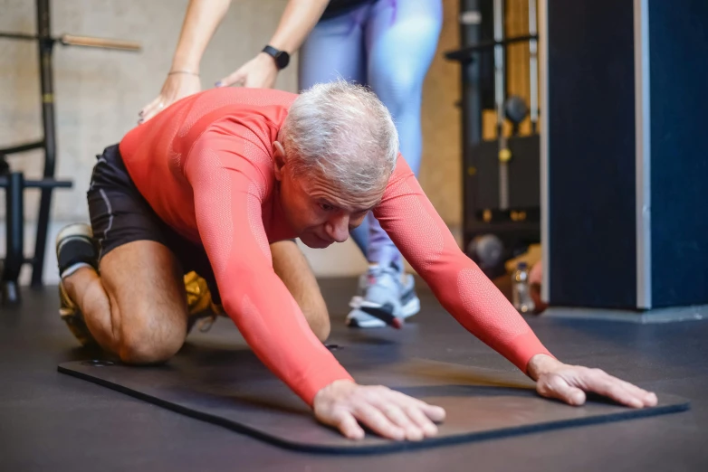 a man doing push ups on a mat in a gym, by Julian Allen, pexels contest winner, hurufiyya, older male, thumbnail, in pain, profile image