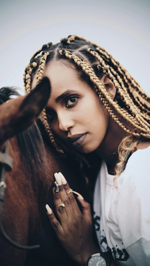 a woman standing next to a brown horse, an album cover, inspired by Afewerk Tekle, pexels contest winner, ethiopian, braids, ((portrait)), square