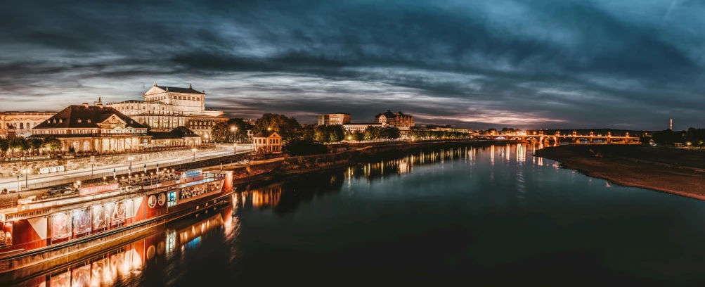 a river running through a city under a cloudy sky, by Adam Szentpétery, pexels contest winner, festival. scenic view at night, late summer evening, river of wine, thumbnail