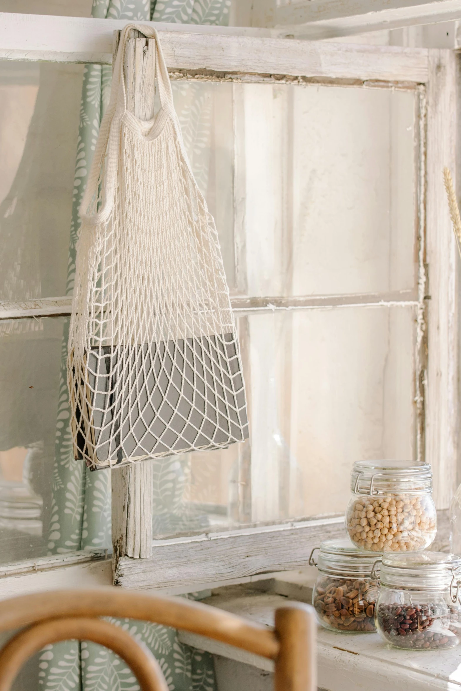 a window with a net hanging on the side of it, handbag, sustainable materials, bath, no cropping