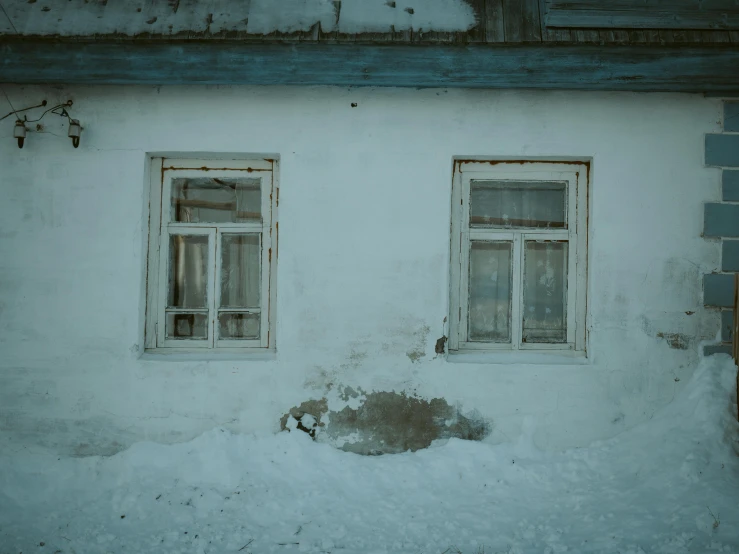 a couple of windows sitting on the side of a building, inspired by Elsa Bleda, pexels contest winner, russian village, icy cold pale silent atmosphere, ground - level medium shot, white