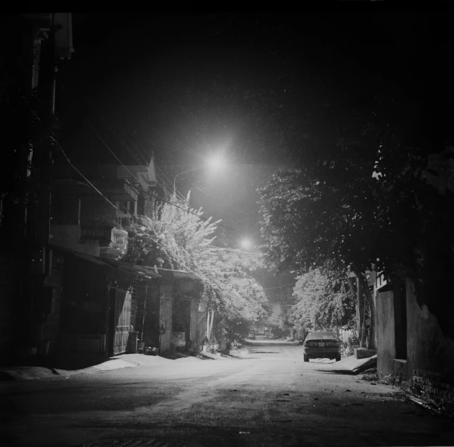 a black and white photo of a street at night, by Maurycy Gottlieb, in style of lam manh, snow, f 2. 8 3 5 mm, an abandoned
