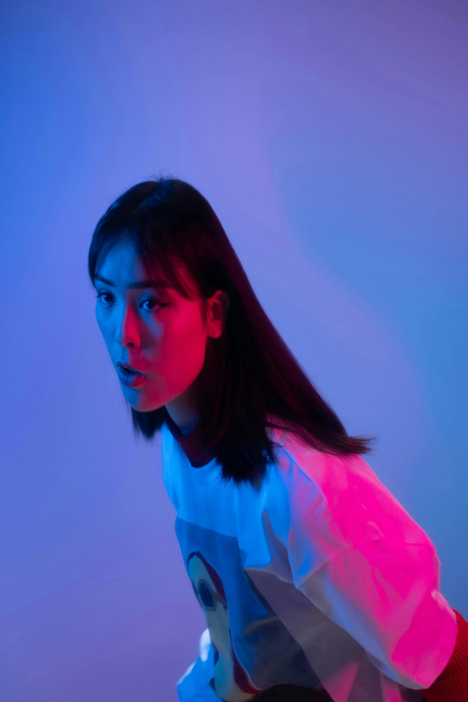 a woman holding a nintendo wii game controller, a picture, inspired by Yanjun Cheng, unsplash, synchromism, red and blue neon, portrait of a japanese teen, looking straight, teamlab