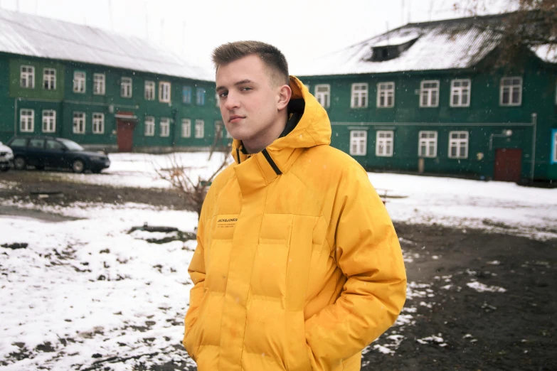 a man in a yellow jacket standing in the snow, an album cover, inspired by Oskar Lüthy, unsplash, hyperrealism, standing in a township street, small blond goatee, russian clothes, reykjavik junior college