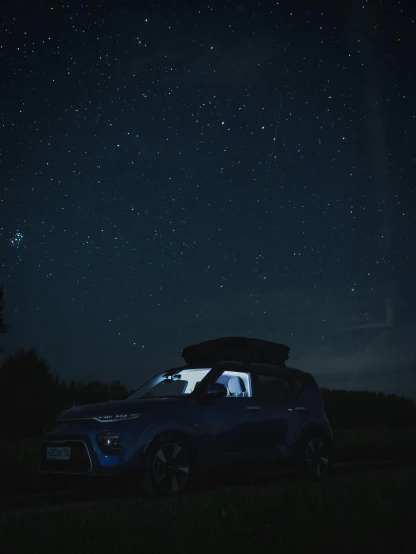 a car parked on the side of a road under a night sky, profile image