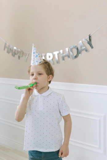 a young boy brushing his teeth in front of a birthday banner, by Pamela Drew, pexels, made out of shiny silver, high resolution product photo, party in front, reptile