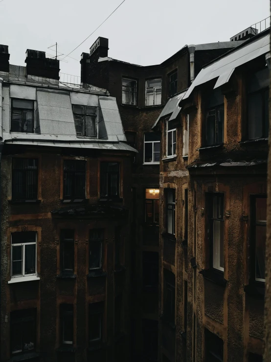 a couple of buildings that are next to each other, inspired by Elsa Bleda, pexels contest winner, renaissance, overcast weather, sovietwave aesthetic, window ( rain ), gray skies