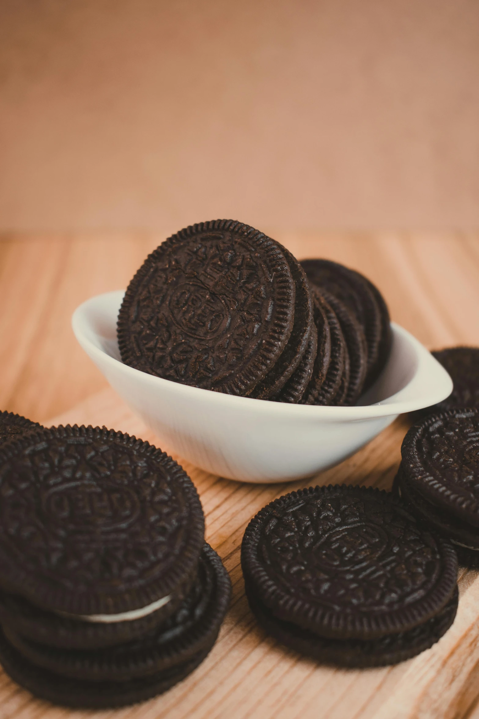 a bowl of oreos sitting on top of a wooden table, detailed product image, heavily upvoted, black, kek