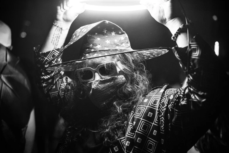 a black and white photo of a man wearing a hat and sunglasses, by Dan Frazier, process art, elaborate lights. mask on face, post malone, gyro zeppeli, patriotism