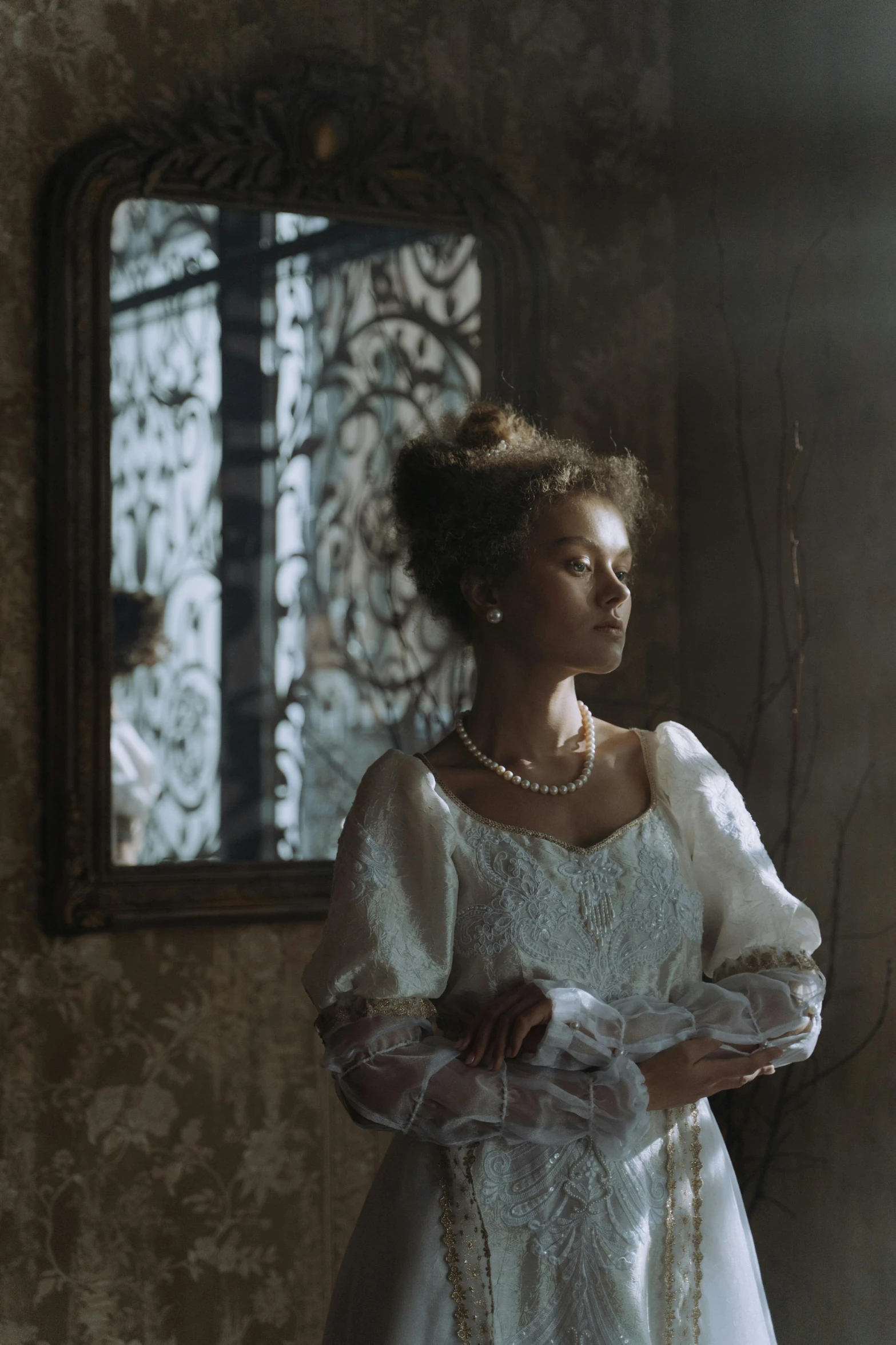 a woman in a wedding dress standing in front of a mirror, inspired by Elsa Bleda, renaissance, dark-skinned, 8 k film still, wuthering heights, doves : : rococo
