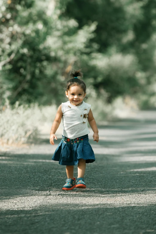 a little girl that is walking down a road, short height, around tree babies running, denim, confidence