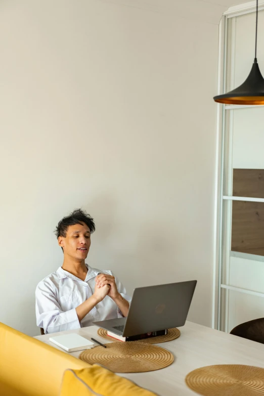 a woman sitting at a table with a laptop, in a room, profile image, asian male, 2019 trending photo