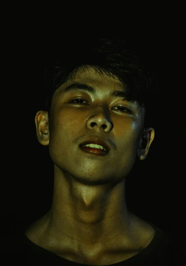 a man standing in the dark with his eyes closed, an album cover, inspired by Russell Dongjun Lu, pexels contest winner, hyperrealism, portrait of modern darna, twink, grimacing, sweaty skin