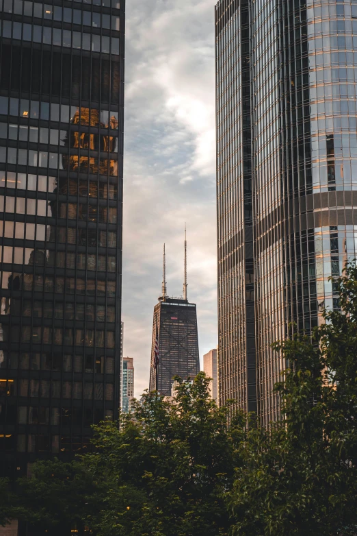 a couple of tall buildings sitting next to each other, by Andrew Domachowski, pexels contest winner, from wheaton illinois, best photo, beautiful views, telephoto shot