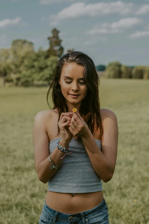 a woman standing in a field holding a flower, anjali mudra, profile image, avatar image, jewelry