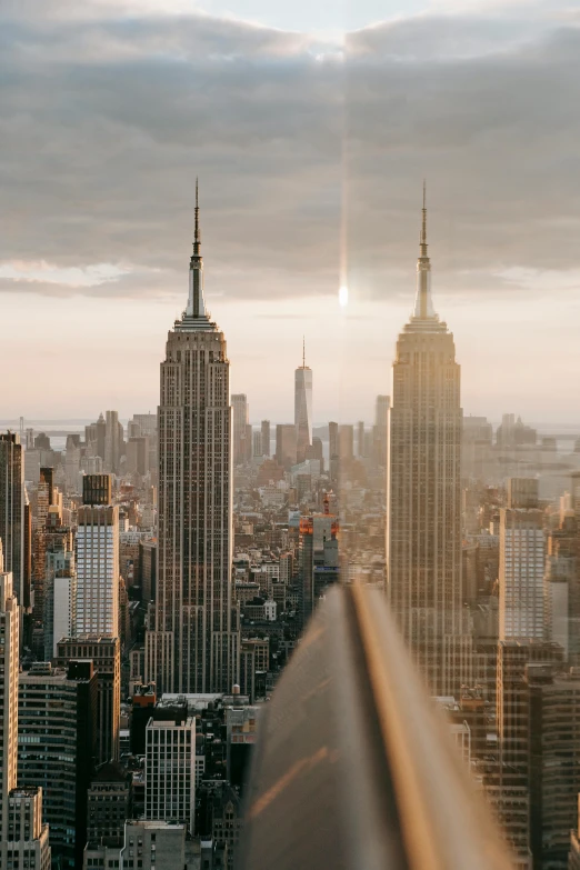 a view of a city from the top of a building, golden hour in manhattan, tall stone spires, 2019 trending photo, ultrawide cinematic