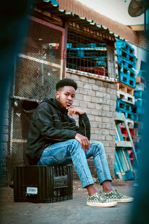 a man sitting on top of a suitcase in front of a building, trending on pexels, graffiti, black teenage boy, thoughtful pose, sitting on a store shelf, profile picture 1024px