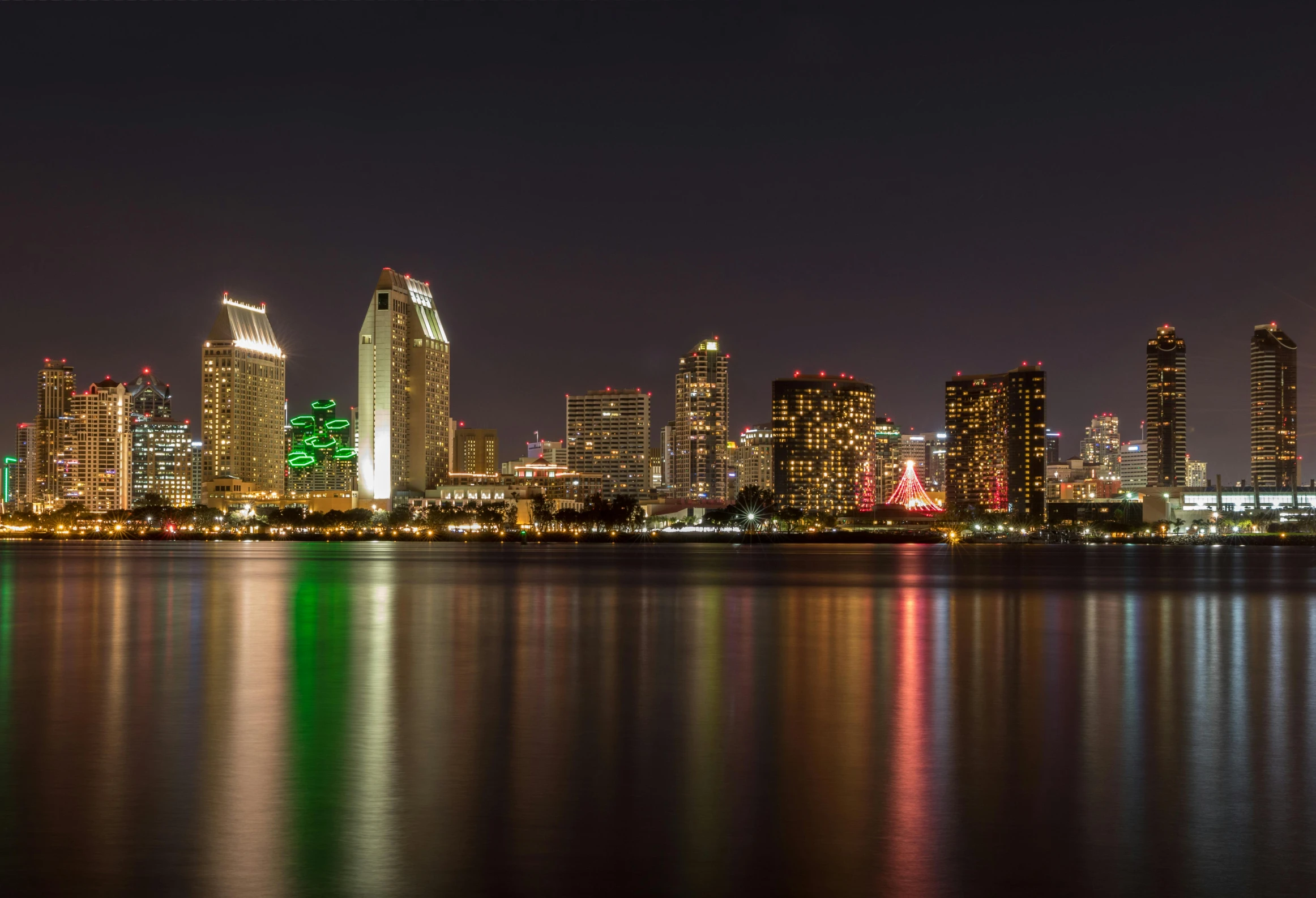 a large body of water with a city in the background, a photo, christmas night, martin sandiego, gigapixel photo, fan favorite