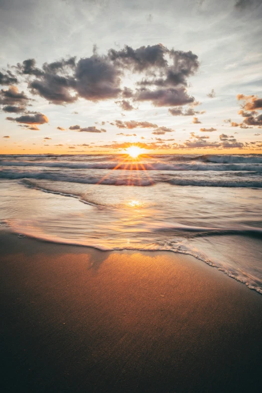 the sun is setting over the water on the beach, unsplash contest winner, renaissance, rippling water, sandy beach, minn, holy rays