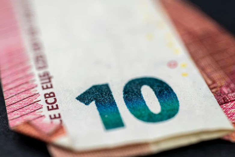 a ten euro bill sitting on top of a table, unsplash, mingei, canada, close-up photo, multi - coloured, shot on sony a 7