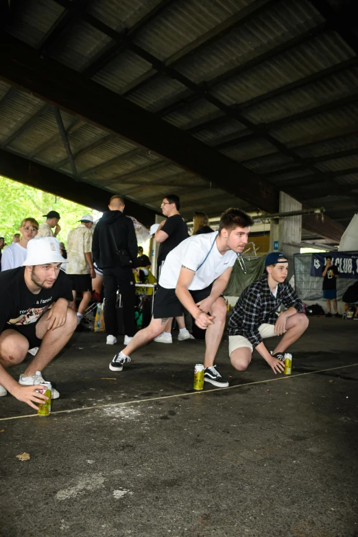 a group of young men riding skateboards down a street, a picture, graffiti, beer being drank and spilled, kneeling at the shiny floor, on a racetrack, street photo