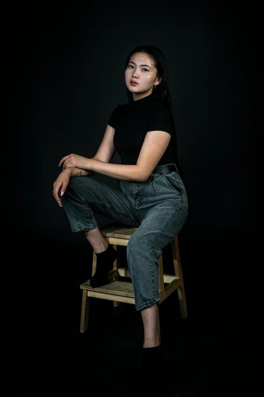 a woman sitting on top of a wooden chair, a character portrait, inspired by Kim Tschang Yeul, unsplash, dark grey backdrop studio, low quality photo, 🤤 girl portrait, standing with a black background