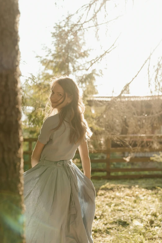 a woman standing next to a horse in a field, long ashy hair | gentle lighting, walking at the garden, next to a tree, portrait featured on unsplash