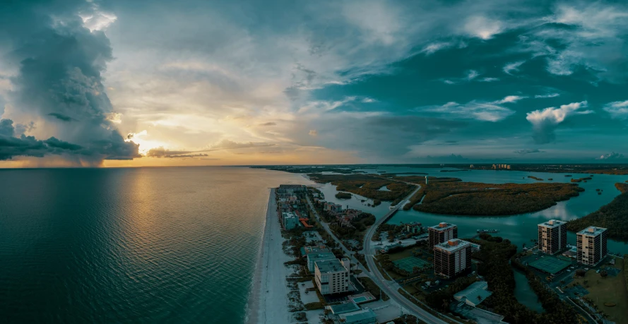 a large body of water next to a beach, by Ryan Pancoast, pexels contest winner, renaissance, sky view, sunset panorama, the emerald coast, slide show