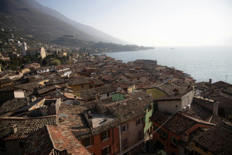 a view of a town next to the ocean, inspired by Niccolò dell' Abbate, pexels contest winner, renaissance, 2 5 6 x 2 5 6 pixels, roofs, hazy, brown