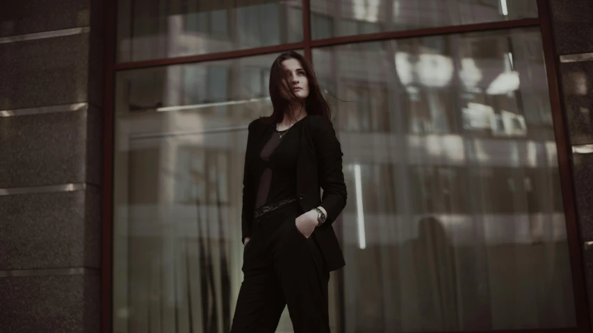 a woman standing in front of a large window, a picture, pexels contest winner, bauhaus, wearing causal black suits, mall goth, handsome girl, yennefer