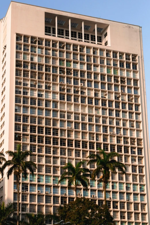 a tall building with palm trees in front of it, 2 5 6 x 2 5 6 pixels, hawaii, steel window mullions, brutalist office buildings