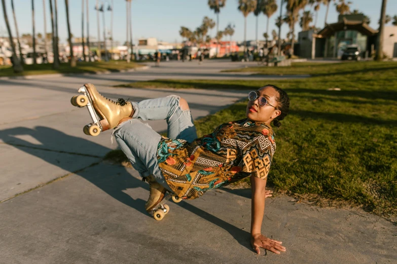 a man laying on top of a skateboard on a sidewalk, by Julia Pishtar, pexels contest winner, gold shirt, kehinde wiley, doing a sassy pose, queer woman