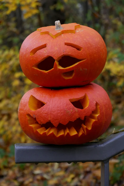 two carved pumpkins stacked on top of each other, slide show, wicked grin, ap