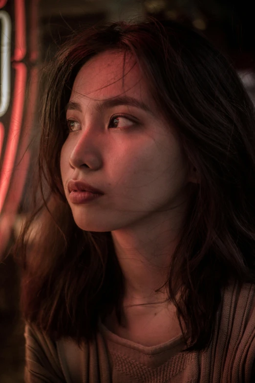 a woman sitting in front of a neon sign, trending on pexels, photorealism, young adorable korean face, cinematic closeup, moody lights, multiple stories